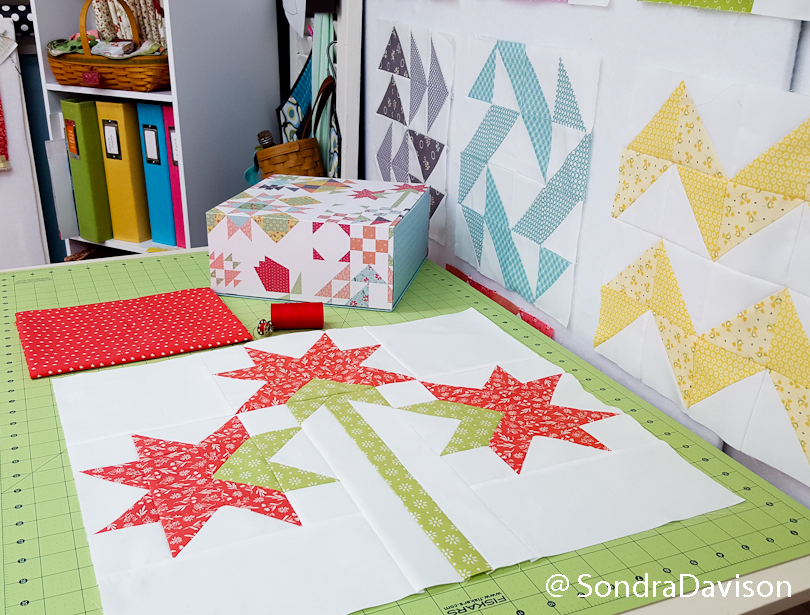 bloomtopia quilt block #2 displayed on studio cutting table